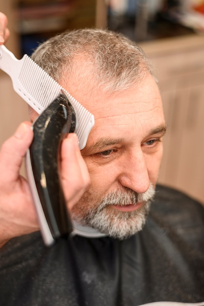 Mature man getting a haircut