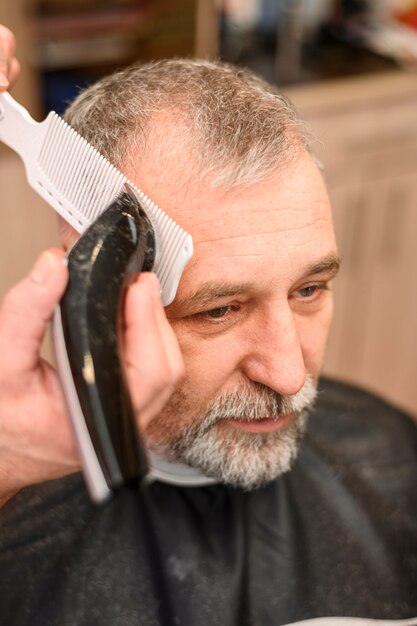 Mature man getting a haircut