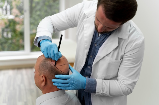 Mature man going through a follicular unit extraction process