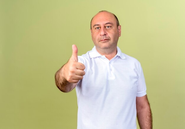 mature man his thumb up isolated on olive green