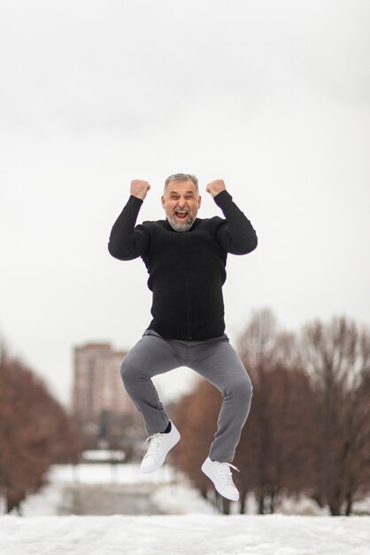 Mature man jumping of happiness