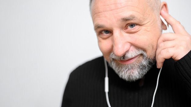 Mature man listening to music close-up