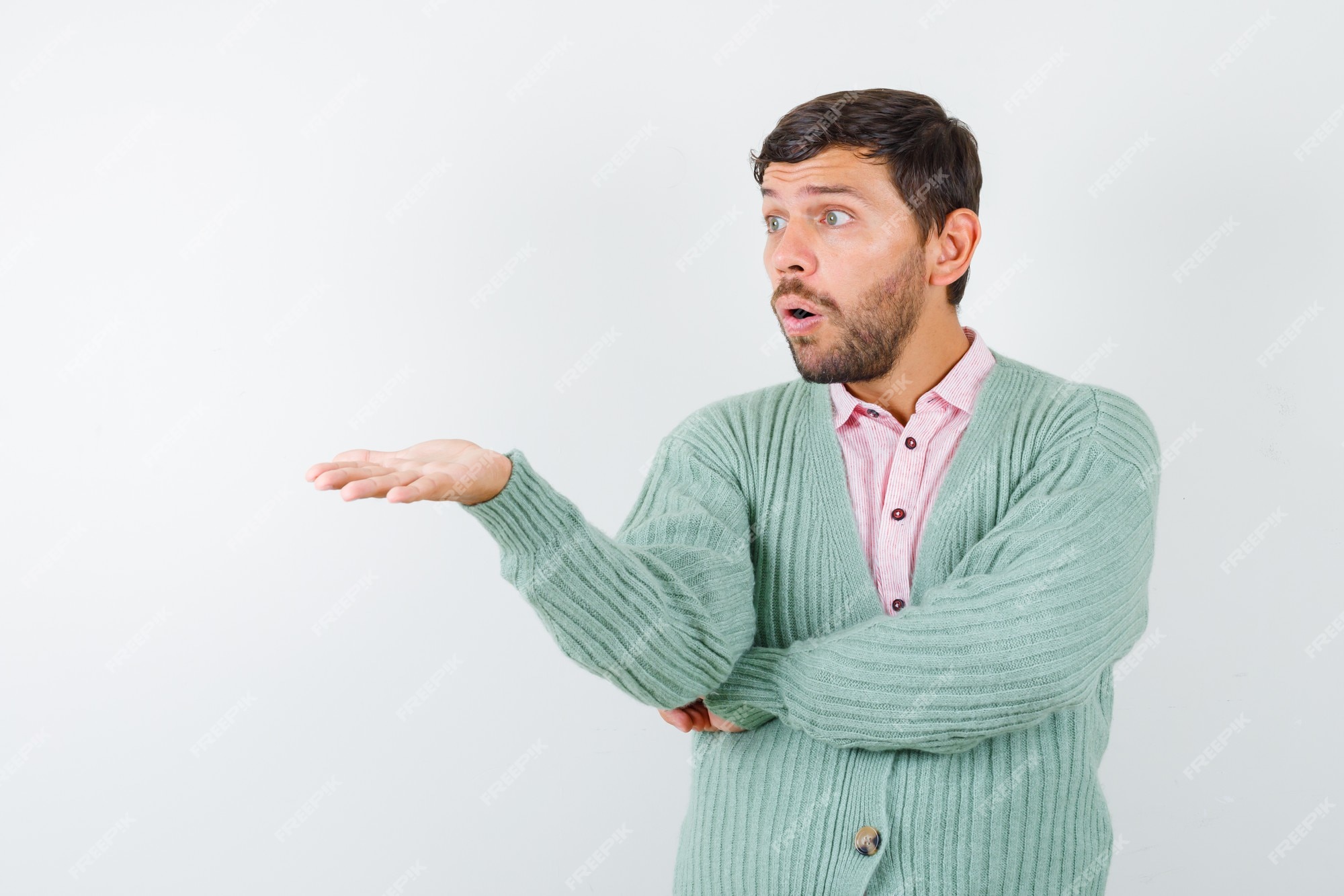 Free Photo  Mature man pretending to show something in shirt