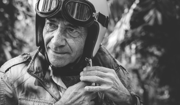 Mature man putting on a helmet