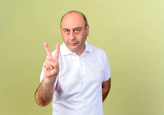 mature man showing peace gesture 