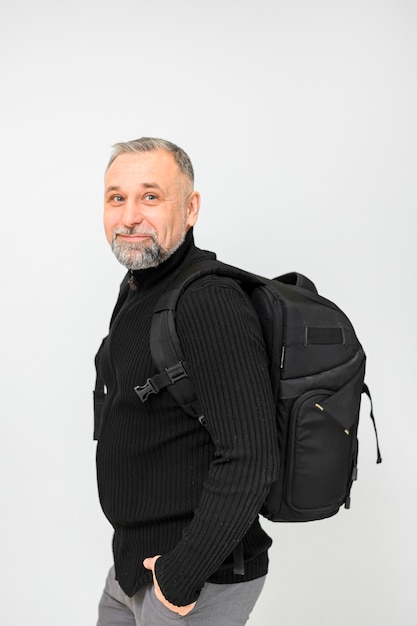 Free photo mature man with backpack posing