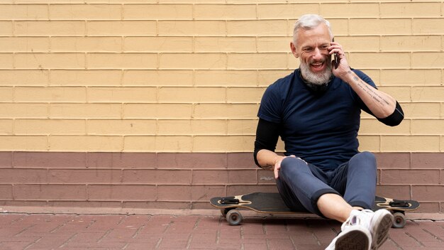 Mature man with sustainable mobility skateboard