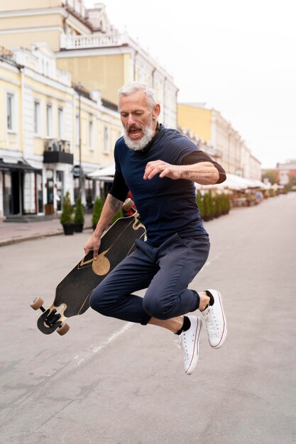 Mature man with sustainable mobility skateboard