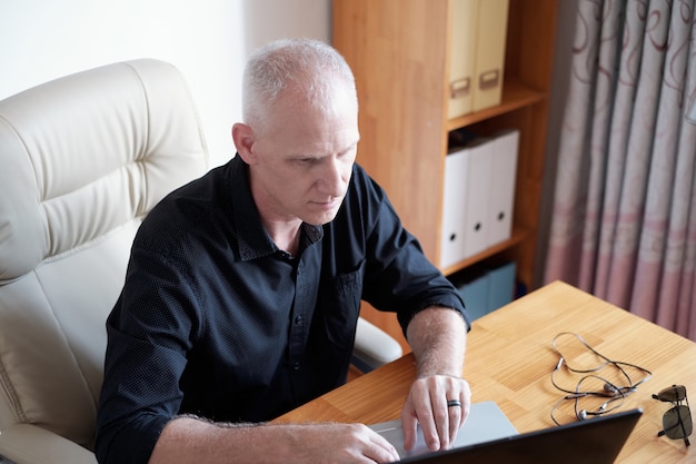 Mature man Working In Office