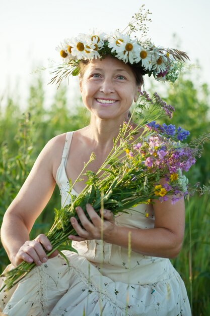 mature  woman in camomile wreath