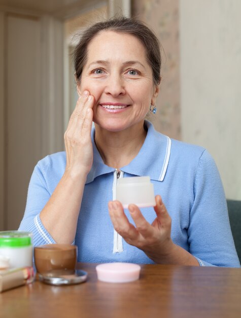 Mature woman doing cosmetic mask