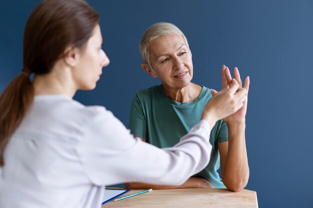 Mature woman doing an occupational therapy session with a psychologist