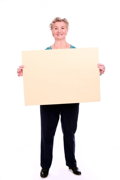 mature woman holding a blank sign