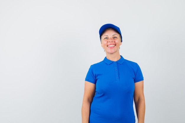 Free photo mature woman looking at front in blue t-shirt and looking optimistic.