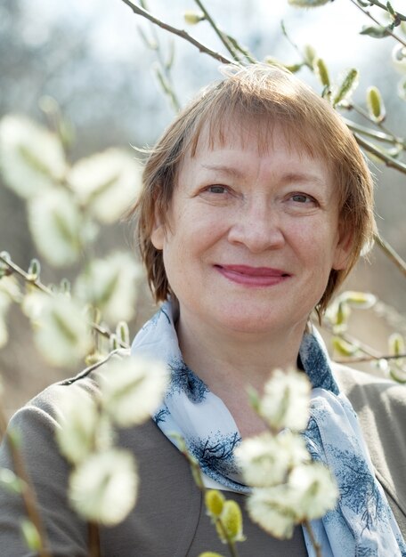 mature woman in spring pussywillow plant