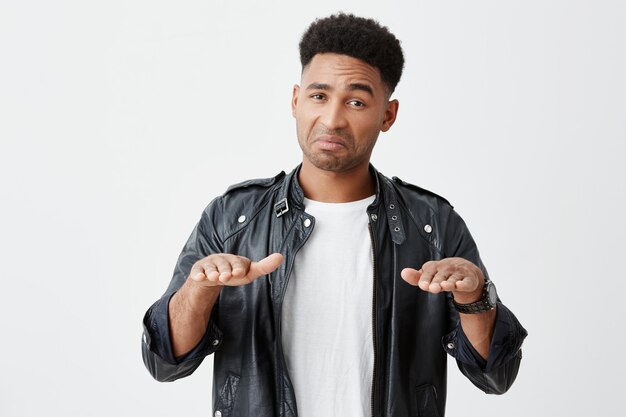 Maybe you chill, man. Calm down. Portrait of mature dark-skinned funny male student with afro hairstyle in casual stylish clothes gesticulating with hands, looking in camera with cynical expression.