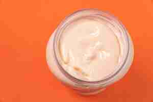 Free photo mayonnaise can on the orange background