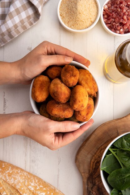 Meal containing croquettes with bacon and a glass of beer