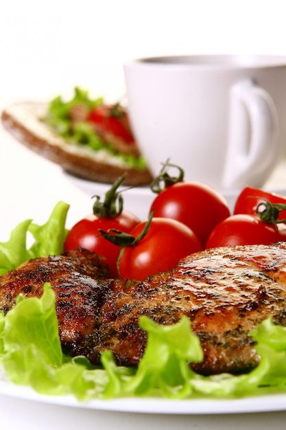 Meal garnish with filet and vegetables and coffee