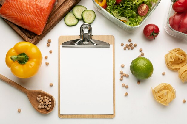 Meal planning clipboard and food assortment