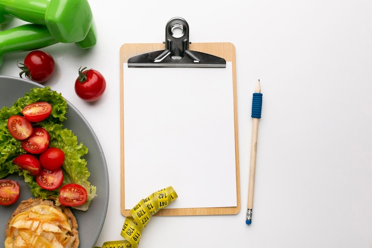 Free Photo meal planning clipboard and food assortment
