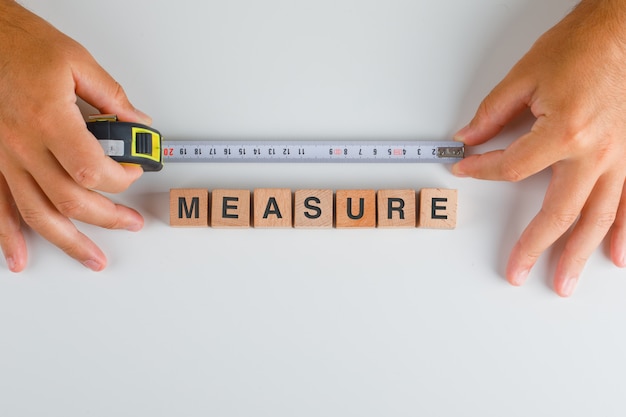 Measuring tape and wooden cubes with the text measure