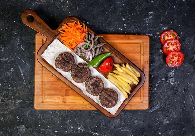 Meat cotlets with vegetable salad and fried potatoes