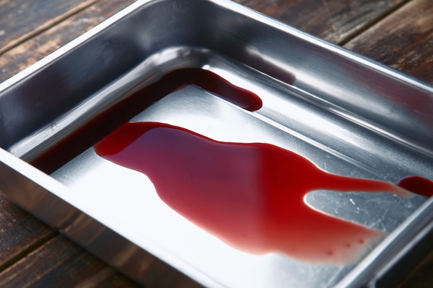 Free photo meat juice, blood in metal steel pot, closeup