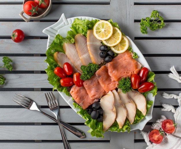 meat plate with olives dogwood and lemon slices