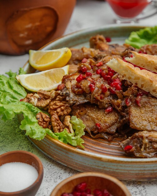 Meat prepared with pomegranate and walnuts