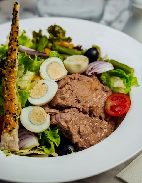 Meat salad with green and eggs