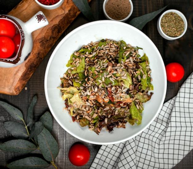 Meat salad with lettuce sprinkled with peeled seeds