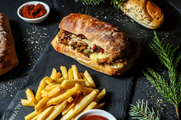 Meat sandwith served with french fries