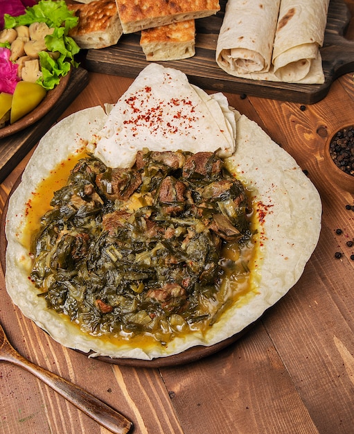 Meat stew, turshu, sebze govurma with onions, green herbs, carrots in broth sauce    