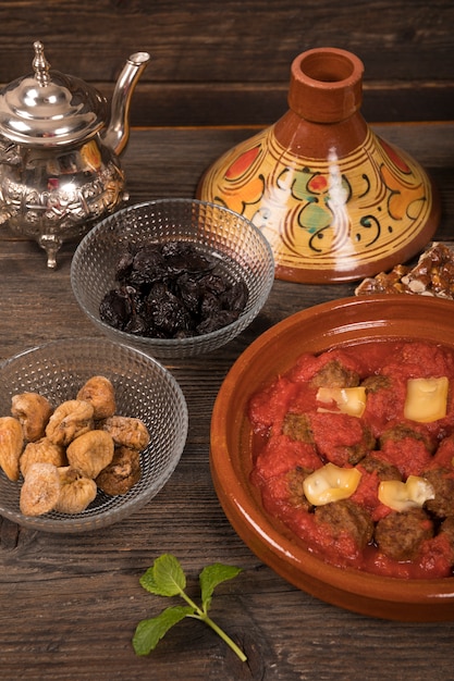 Meat with dried fruits and teapot