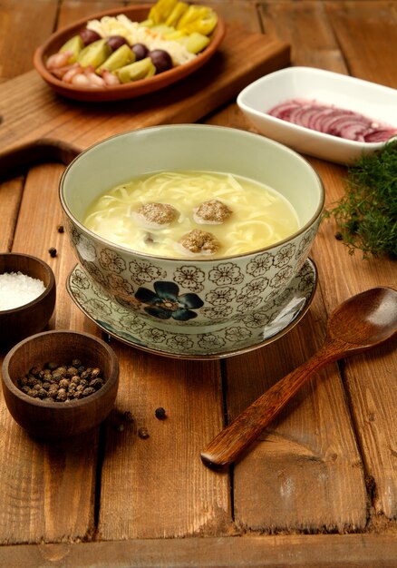 Meatball soup with noodles served in bowl