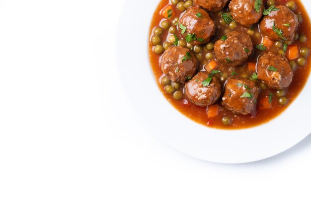 Meatballs green peas and carrot with tomato sauce isolated on white background
