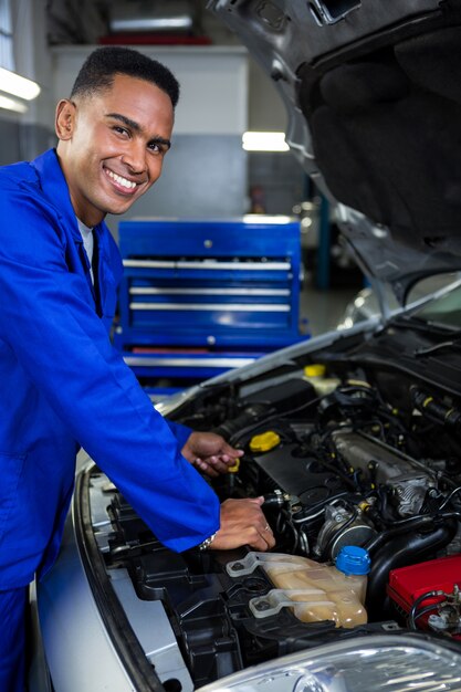Mechanic checking the oil level in a car engine