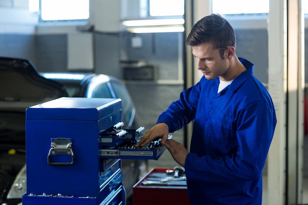 Mechanic checking tool in tool box