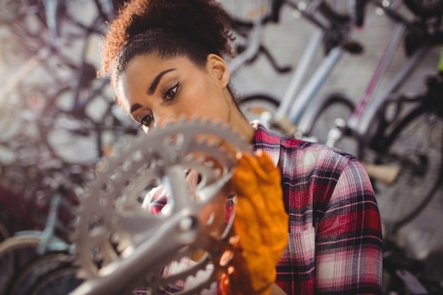 Free photo mechanic examining a bicycle gear