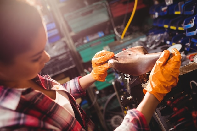 Mechanic examining a bicycle seat