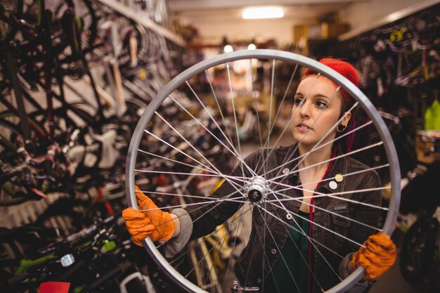 Mechanic examining a bicycle wheel