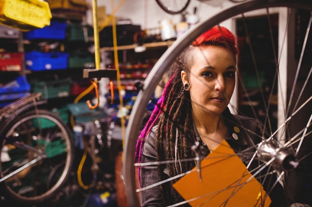 Mechanic examining a bicycle wheel