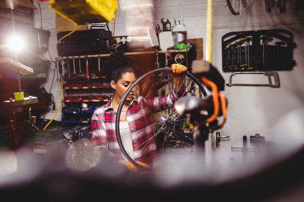 Mechanic examining a bicycle wheel