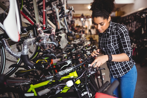 Mechanic examining bicycles