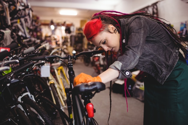 Mechanic examining bicycles