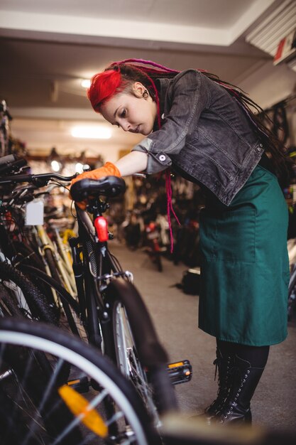 Mechanic examining bicycles