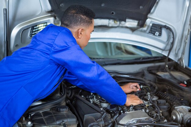 Mechanic examining car engine