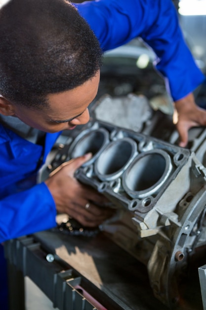 Free photo mechanic examining a car parts