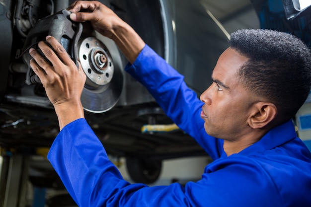 Mechanic fixing car brake